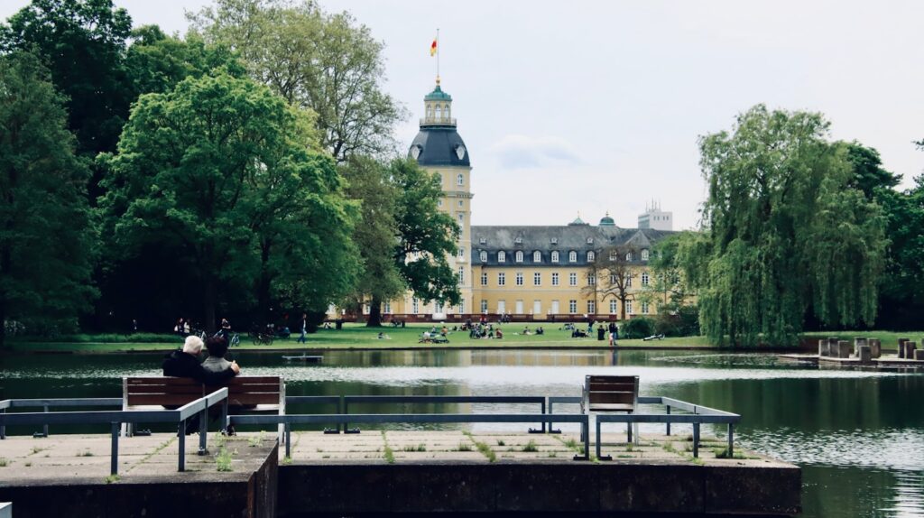 people sitting on bench near body of water during daytime