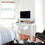 white wooden desk near bed inside the room